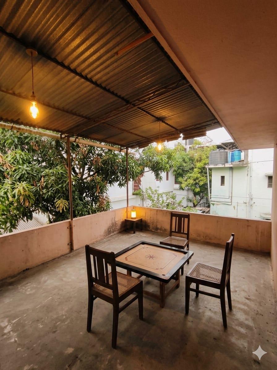 Rooftop terrace common area with carrom board at Hive Gents PG